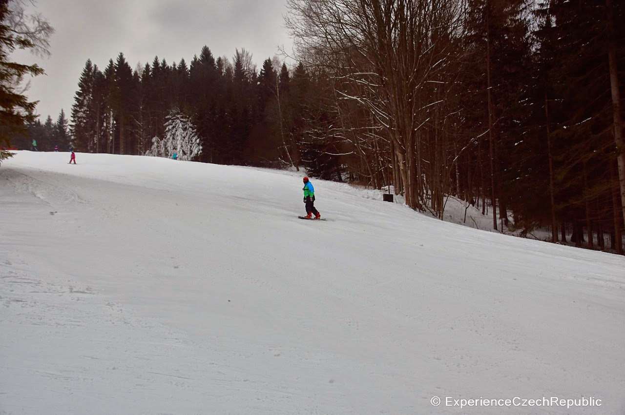 Pawlin – Malá Morávka in Czech Republic - a person on a snowboard going down a hill.