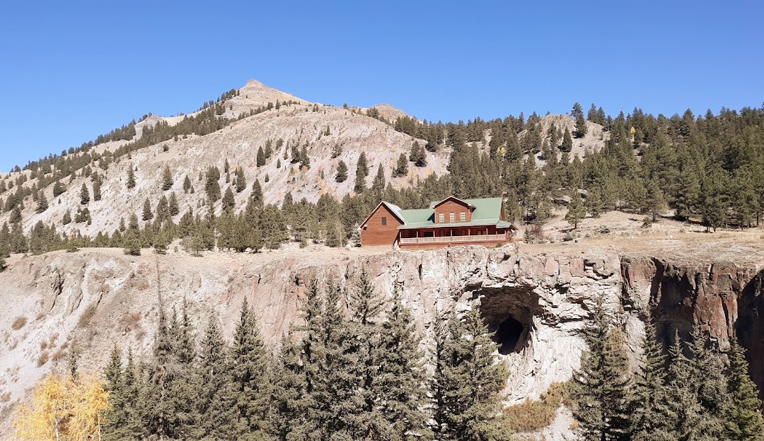 A picturesque view at the Lake City Ski Hill in Colorado USA. The image features a beautifully constructed lodge and mountain hut nestled at the bottom of a snowy mountain creating an inviting ski resort ambiance.