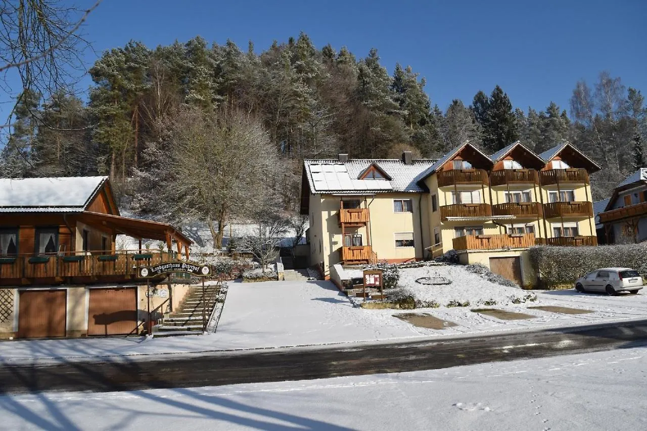 Brennberglift – Etzelwang in Germany - a row of houses with snow on the ground.