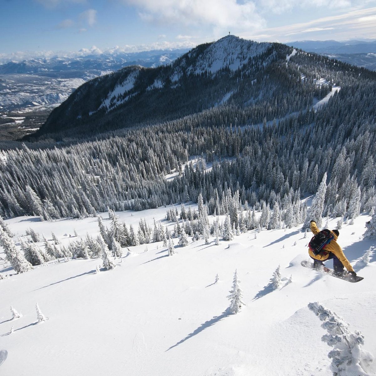 Red Mountain Resort in Canada - a person riding a snowboard down a snowy slope.