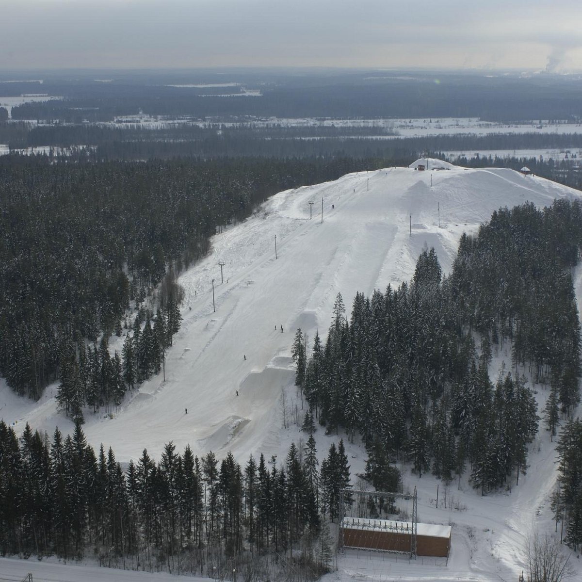 Mielakka in Finland - a snow covered ski slope with trees in the background.