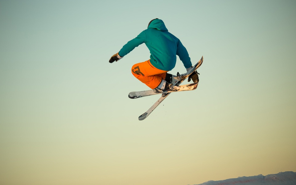Mielakka in Finland - a man flying through the air while riding a snowboard.