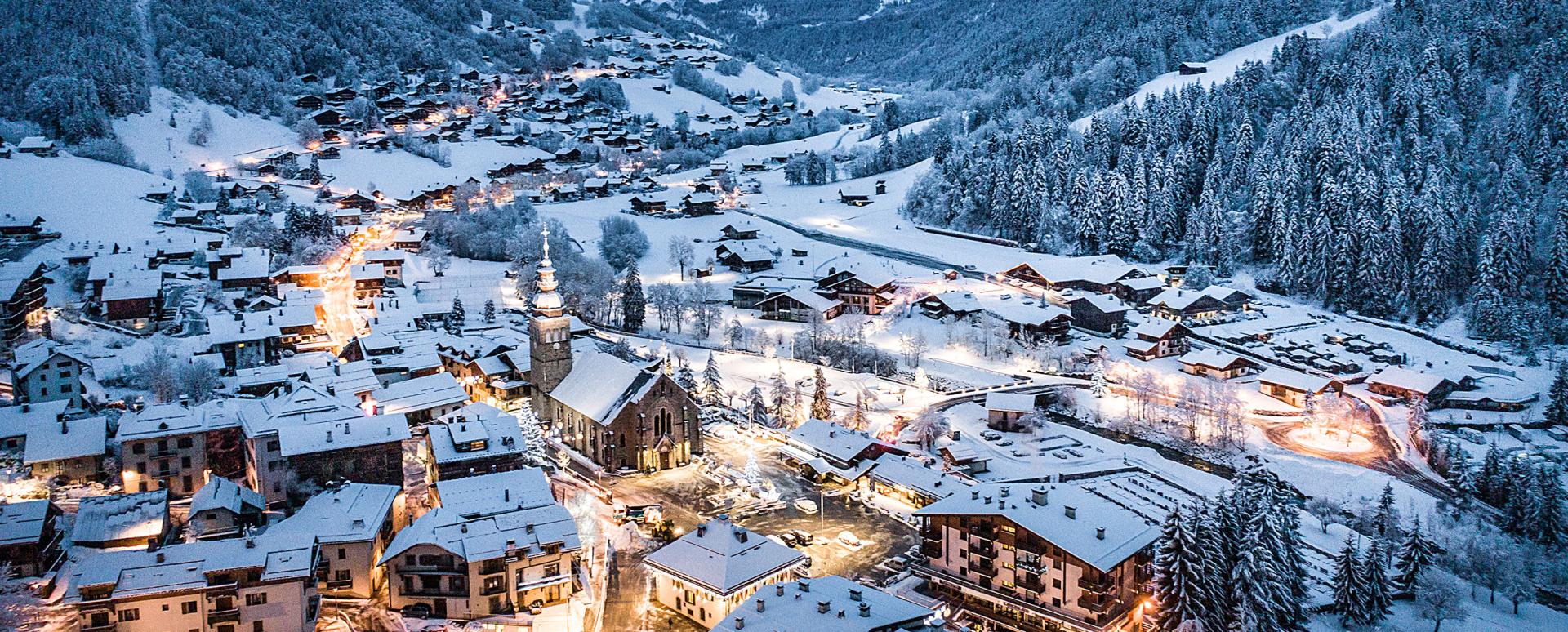Le Grand Bornand Chinaillon in France - a snowy town in the mountains at night.