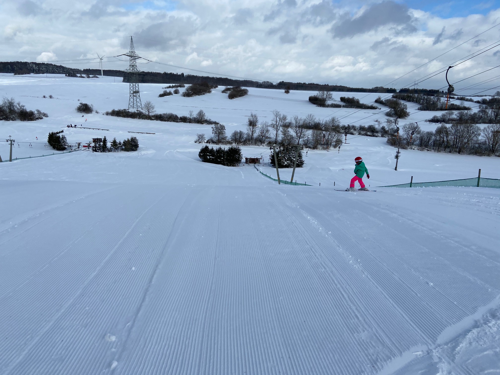 Am Richtergrund – Hermsdorf in Germany - a person riding a snowboard down a hill.