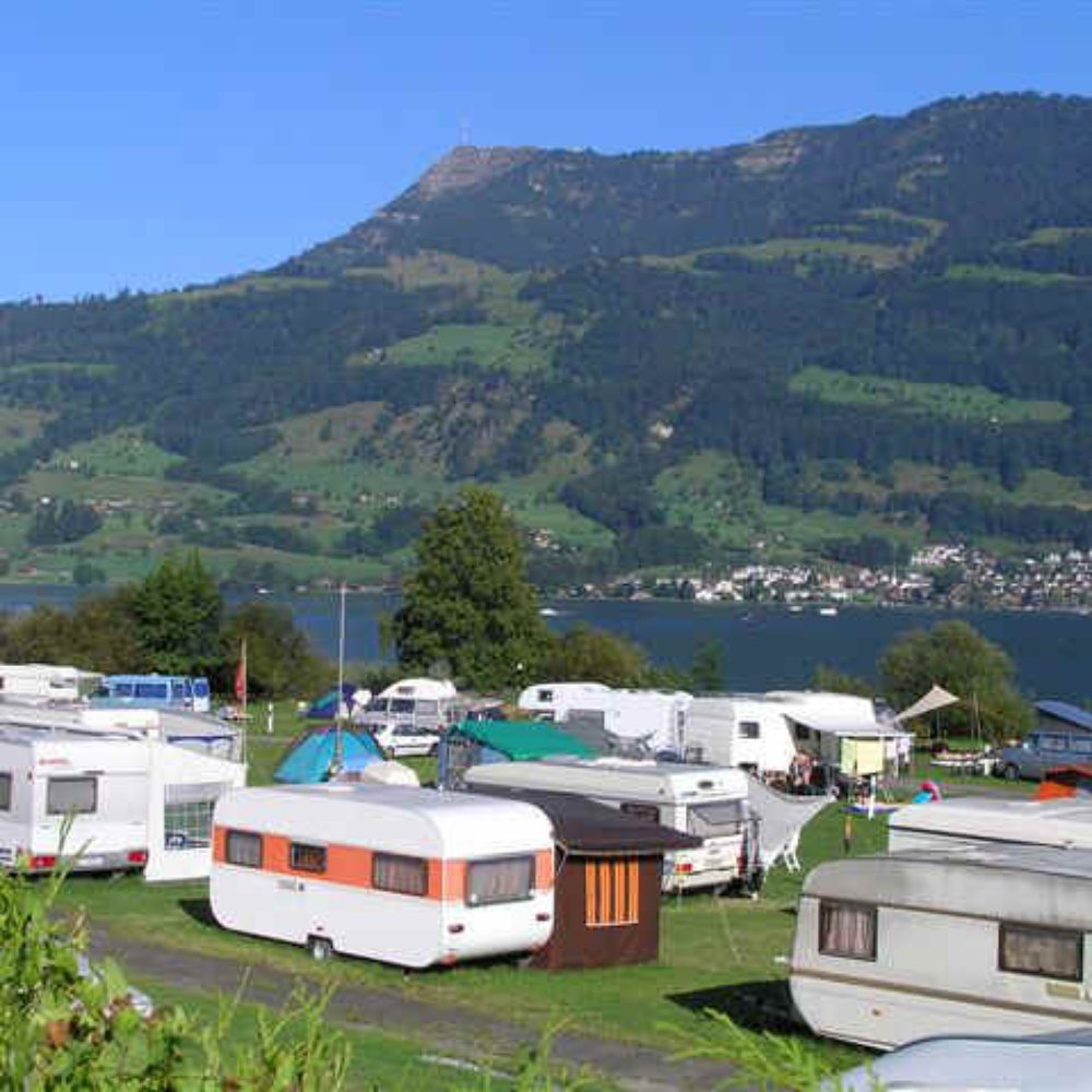 Heiti – Gsteig bei Gstaad in Switzerland - a group of rv parks with mountains in the background.