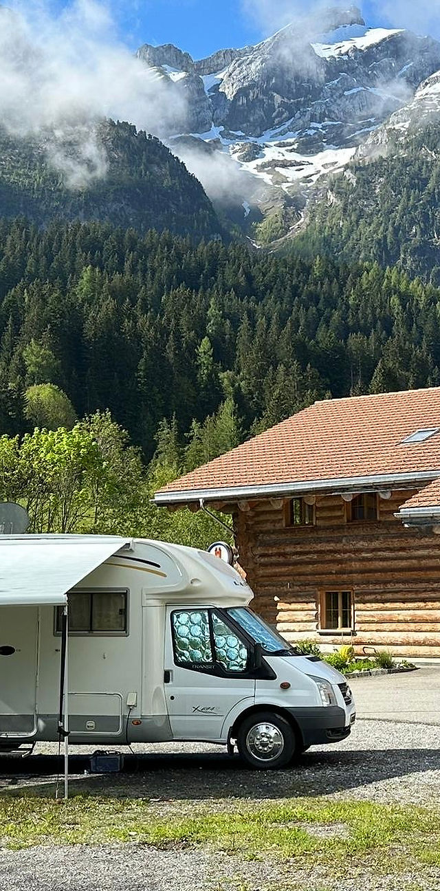 Heiti – Gsteig bei Gstaad in Switzerland - a white van parked in front of a mountain.