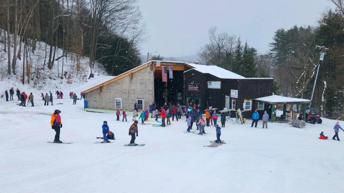 Storrs Hill – Lebanon in USA - a group of people skiing down a snow covered slope.