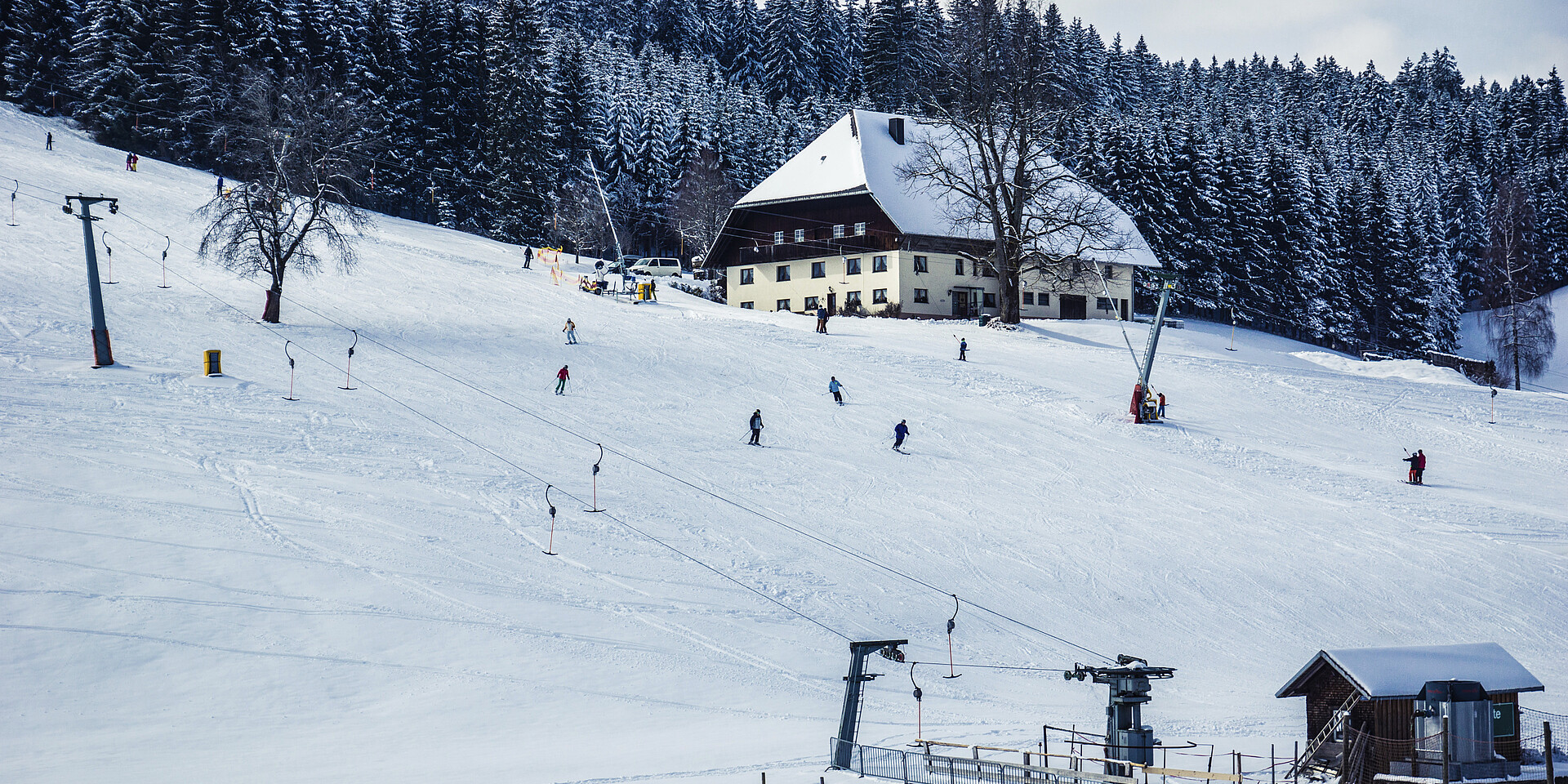 Kalte Herberge – Urach in Germany - a group of people skiing down a snowy hill.