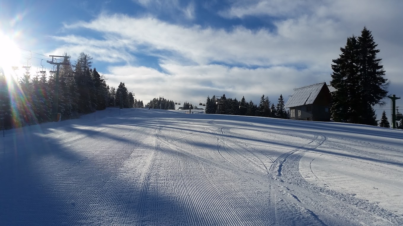 Brunni – Alpthal in Switzerland - a snow covered ski slope with trees in the background.