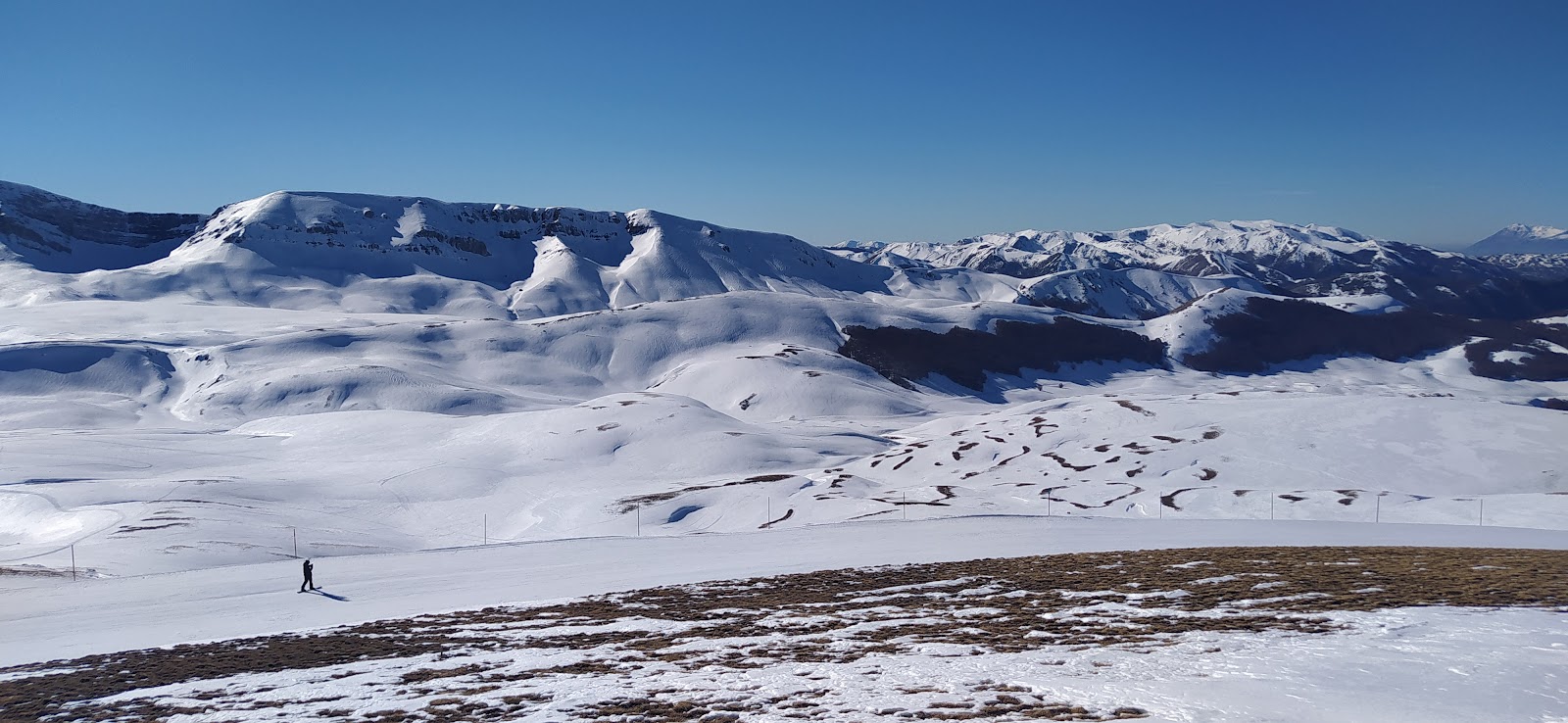 Alto Sangro – Roccaraso | ​Rivisondoli in Italy - a person standing on top of a snow covered mountain.