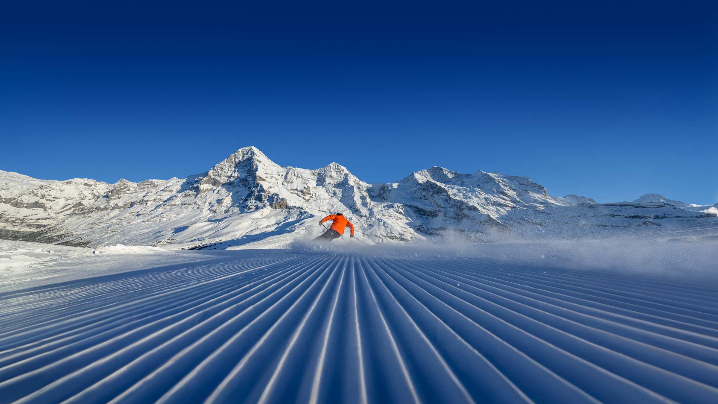 Wengen in Germany - a person skiing down a snowy slope in the mountains.