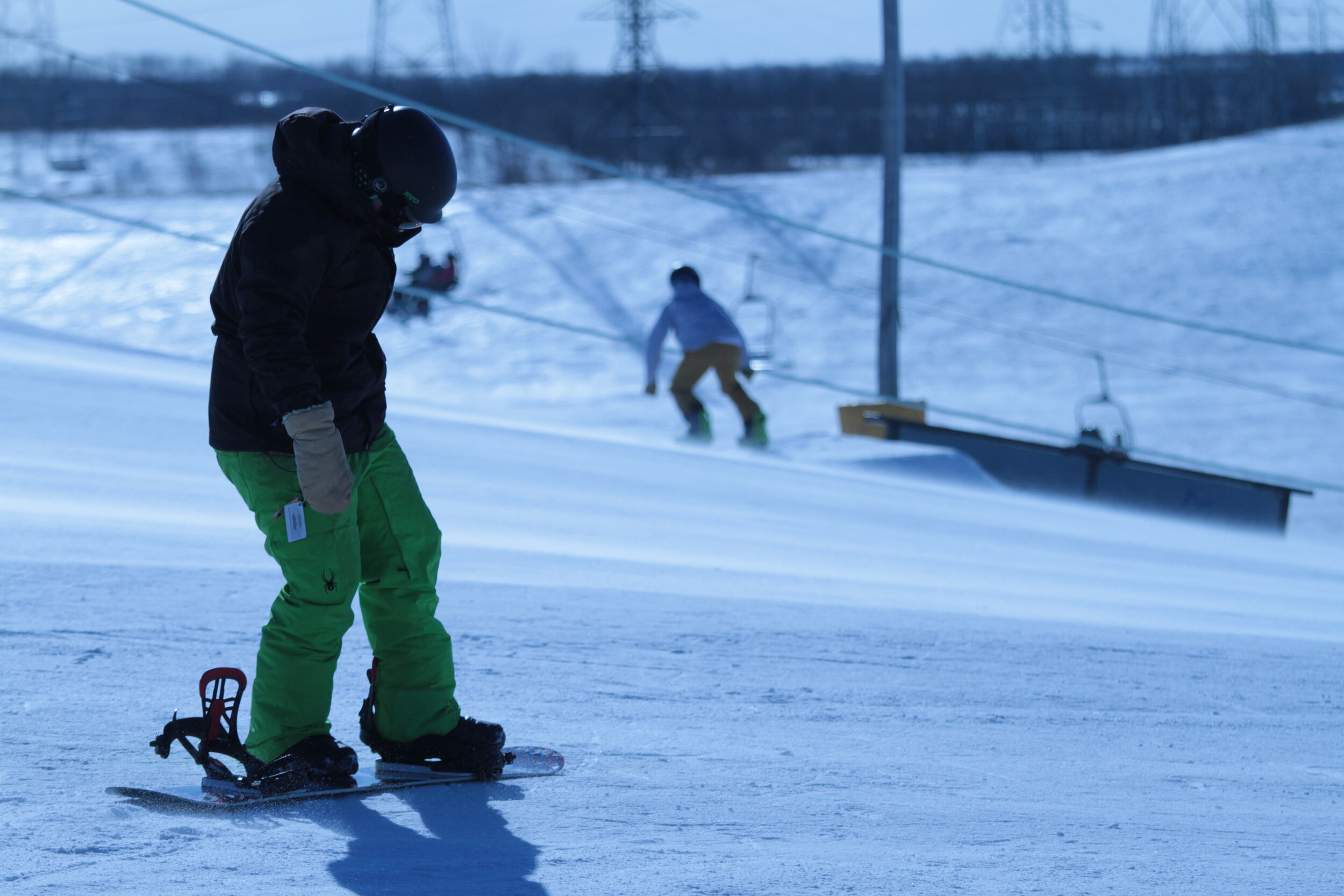 Spring Hill Winter Park in Canada - a person on a snowboard in the snow.