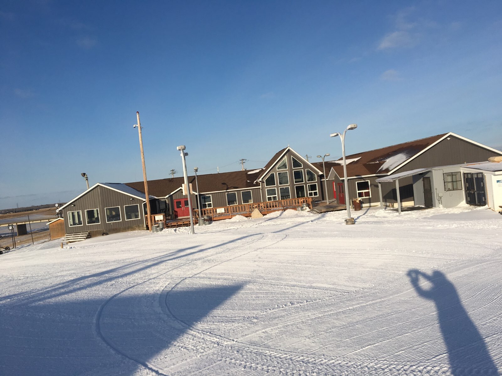 Spring Hill Winter Park in Canada - a snow covered field with houses in the background.