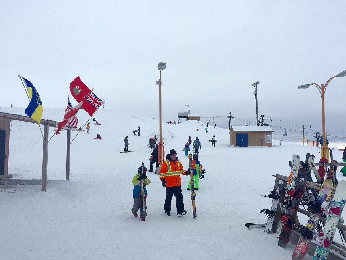 Spring Hill Winter Park in Canada - a group of people standing on top of a ski slope.