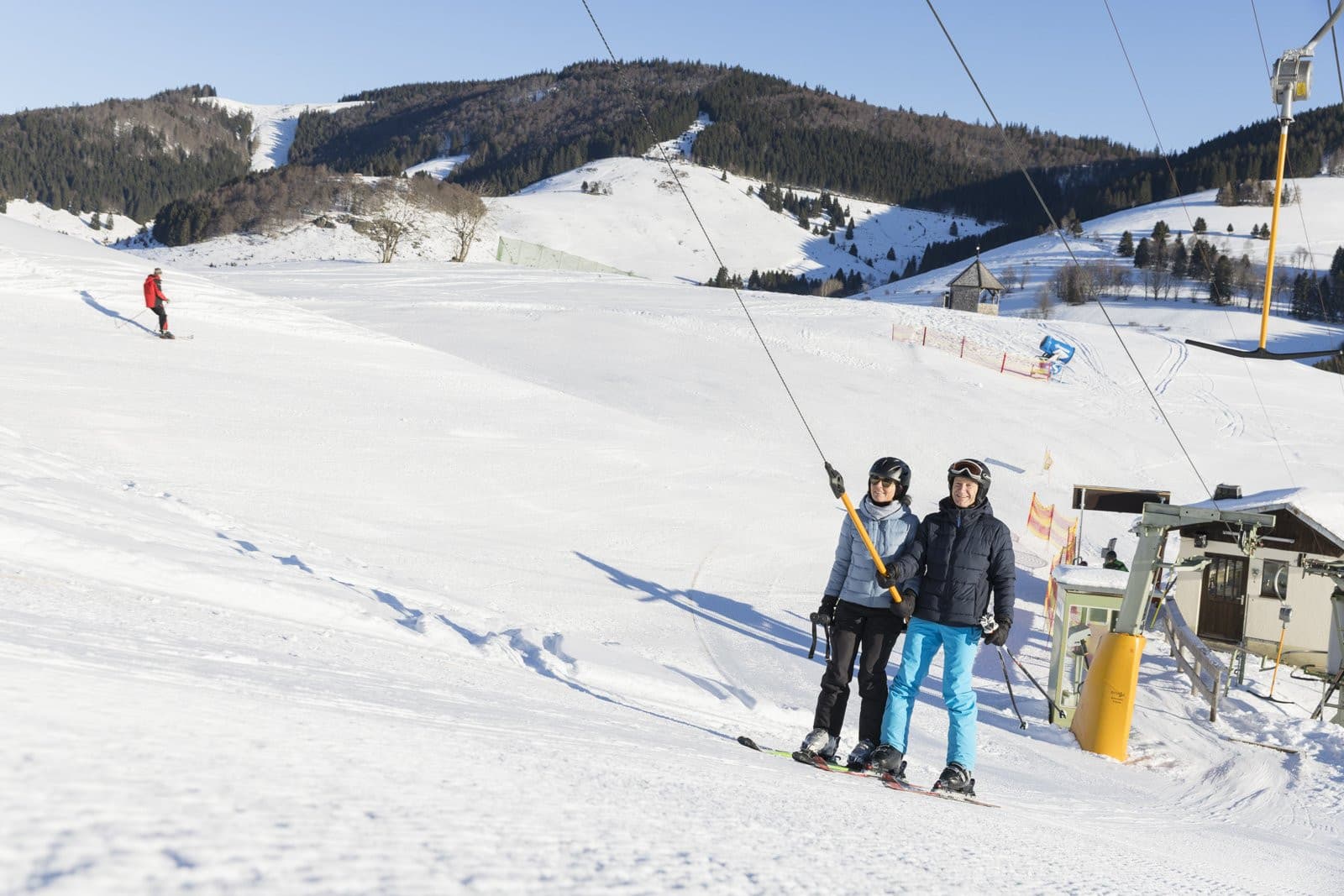 Hornlift – Fröhnd in Germany - two people are skiing down a snowy hill.