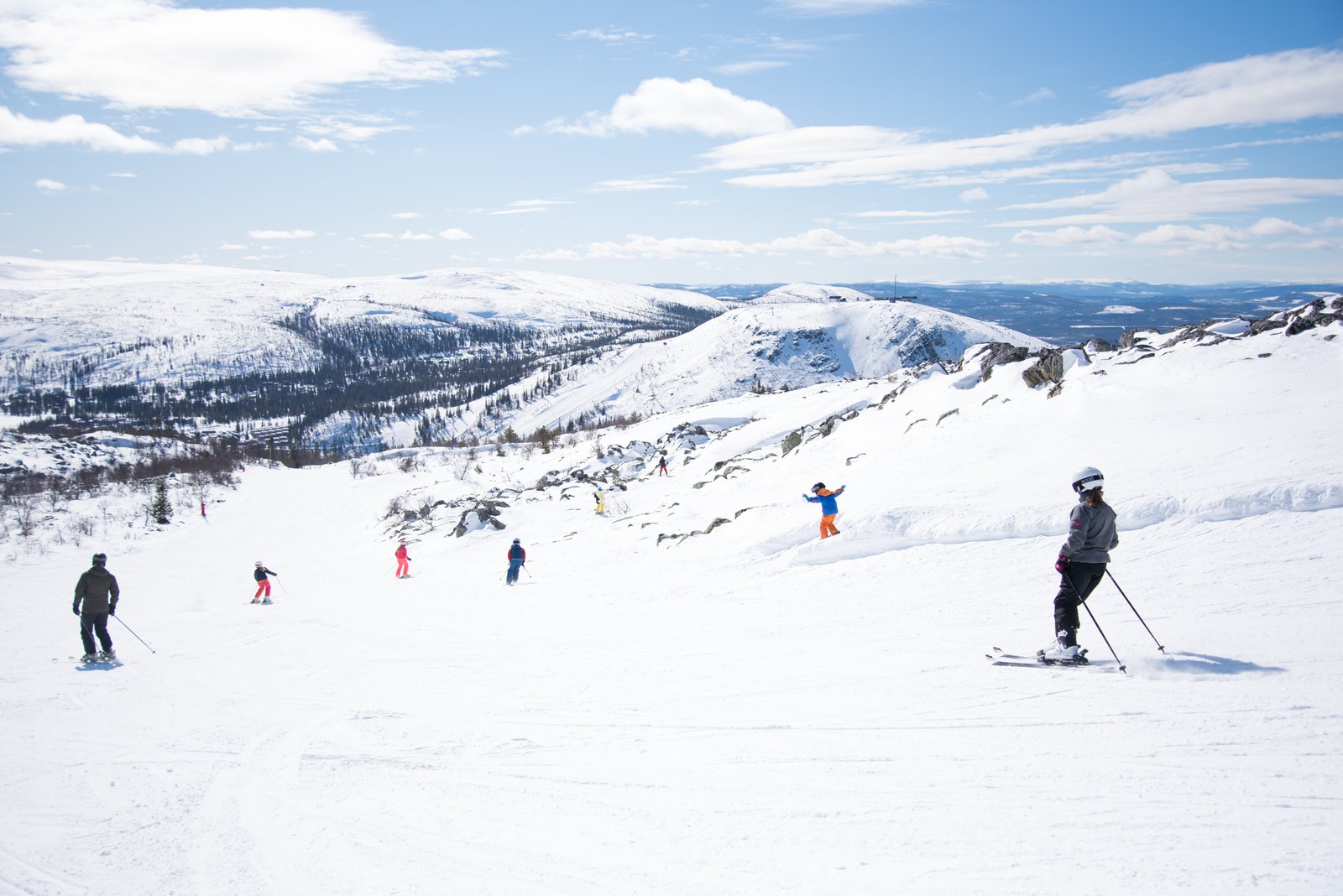 Vemdalsskalet in Sweden - a group of people skiing down a mountain.