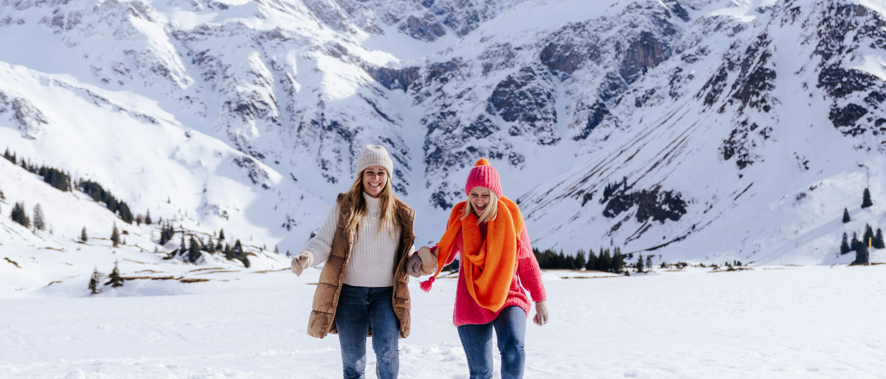 Sportgastein in Austria - two women walking in the snow in the mountains.