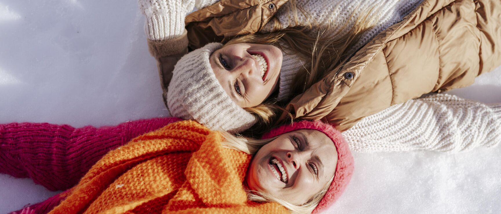 Sportgastein in Austria - two women laying in the snow.
