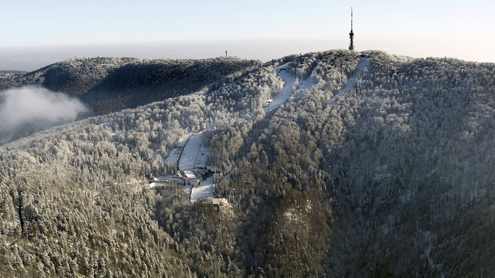 Velebno in Croatia - a mountain covered in snow with a radio tower.
