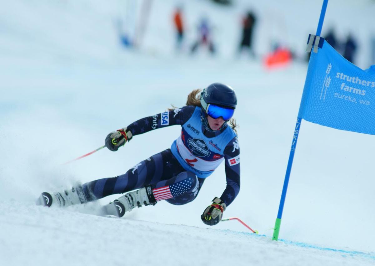 Velebno in Croatia - a woman skiing down a snow covered slope.