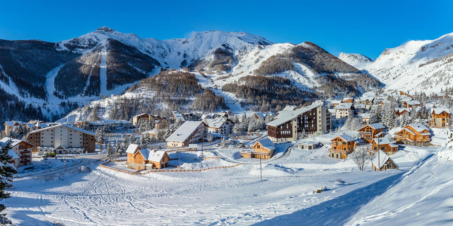 Auron in France - a snowy village with mountains in the background.