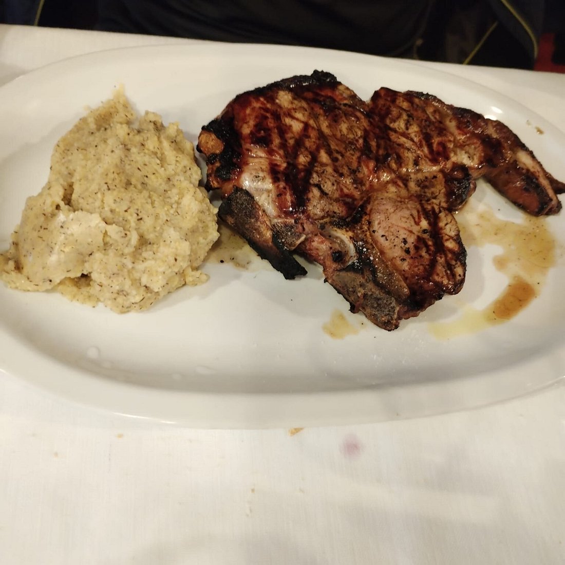 Monte Corno – Lusiana in Italy - a plate with meat and rice on it.