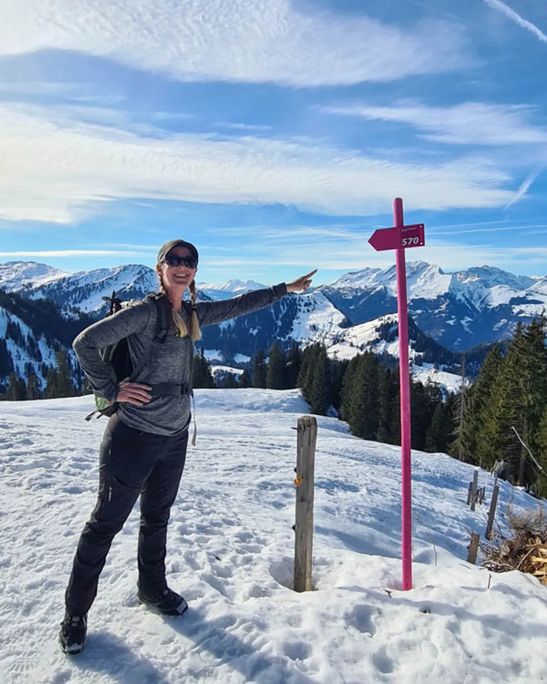 Grüsch Danusa in Switzerland - a woman standing on top of a snow covered mountain.