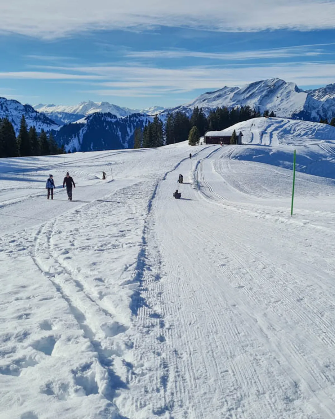 Grüsch Danusa in Switzerland - a group of people skiing down a snowy slope.