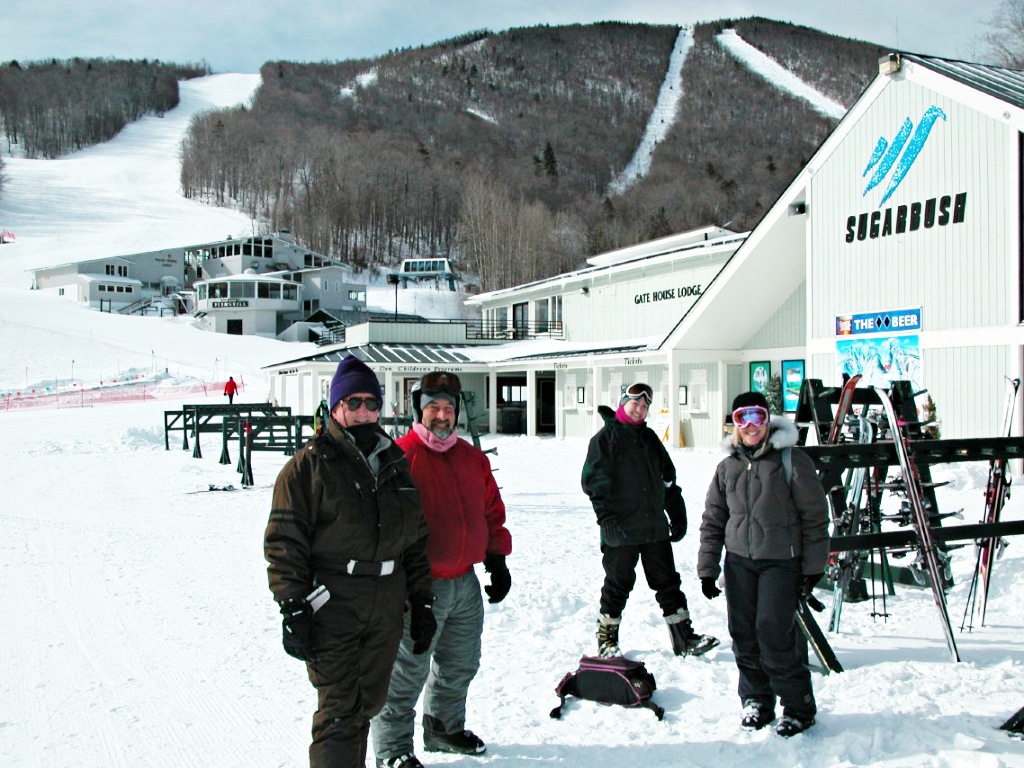 Ascutney Mountain in USA - a group of people standing on top of a snow covered slope.