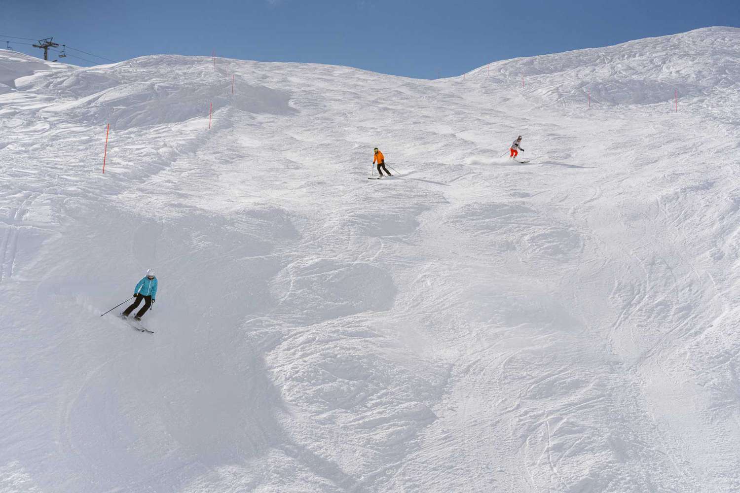 Gemsstock – Andermatt in Switzerland - two people skiing down a snow covered mountain.