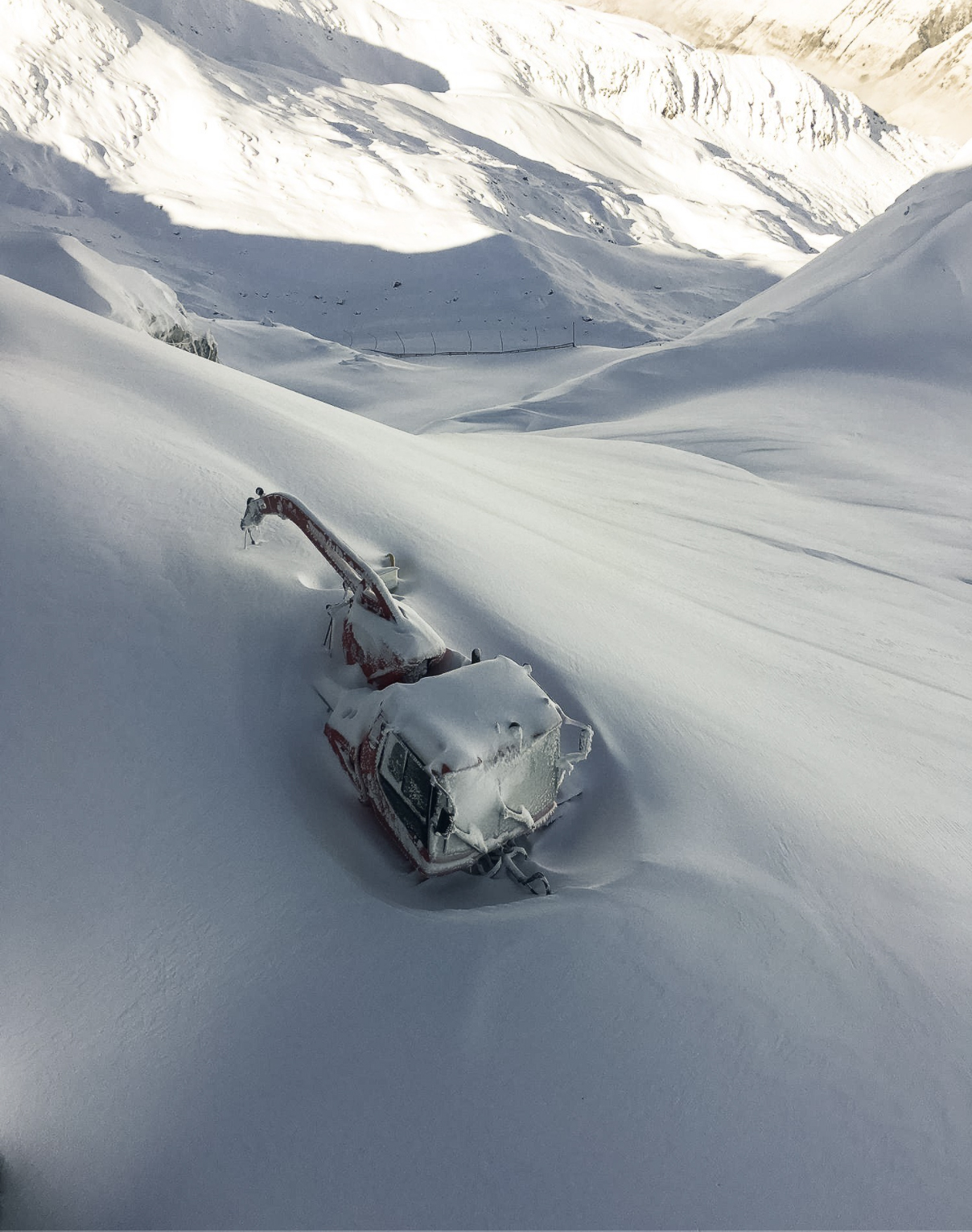 Gemsstock – Andermatt in Switzerland - a car buried in the snow in the mountains.