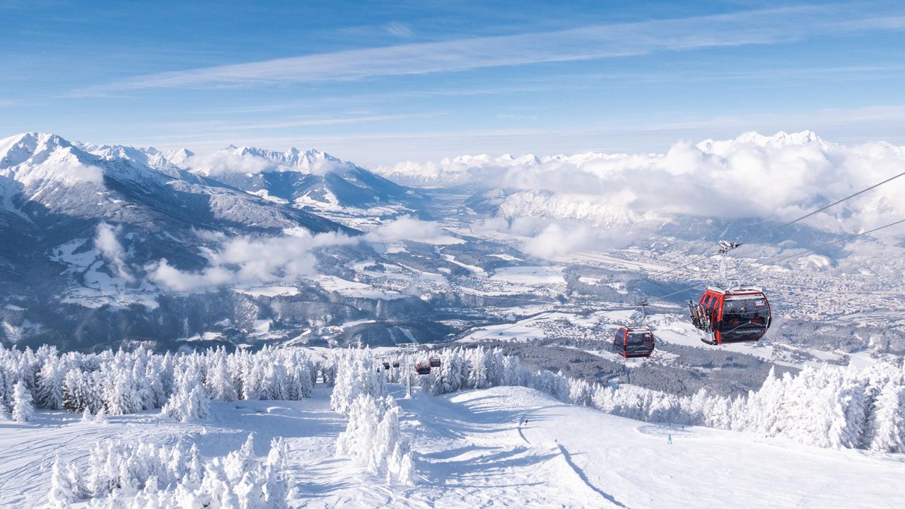 Patscherkofel – Innsbruck-Igls in Austria - a ski lift going up a snowy mountain.