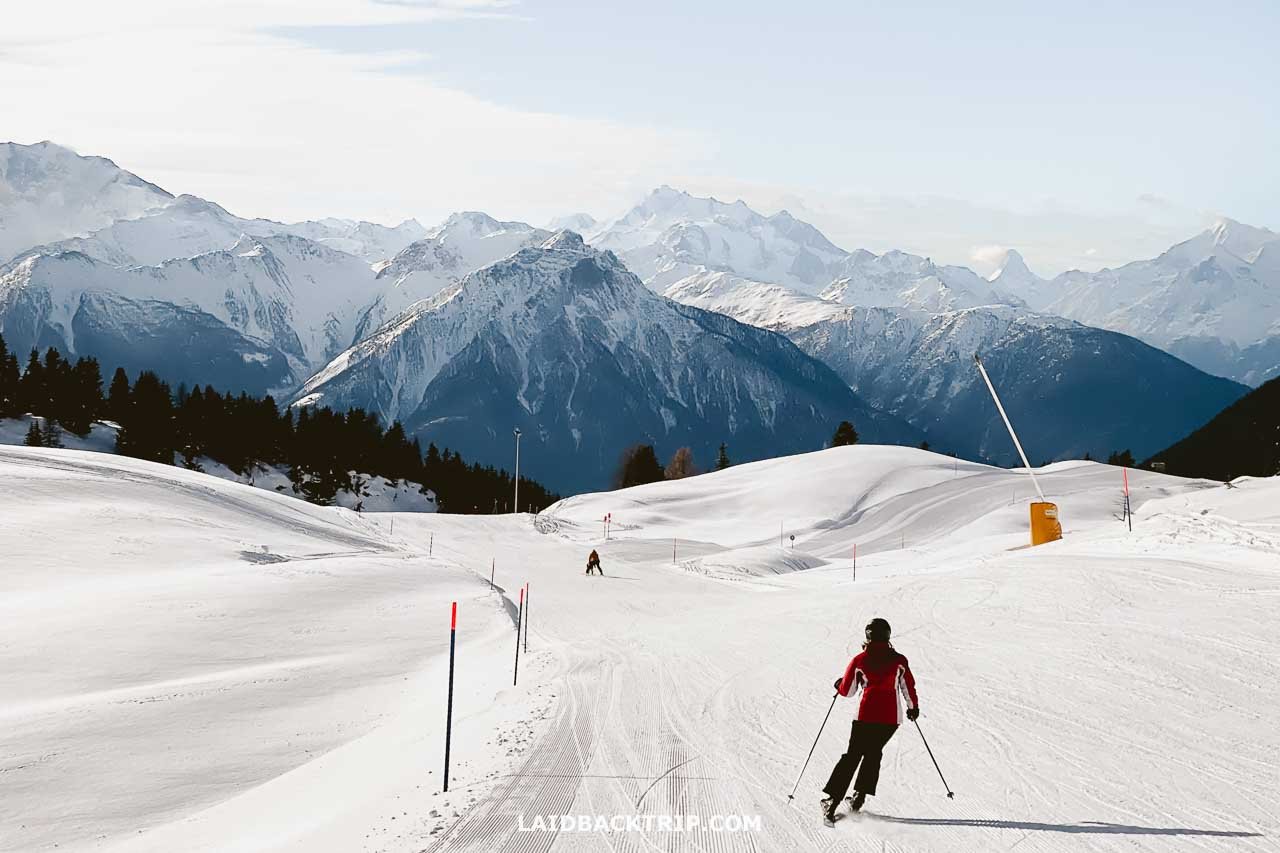 Aletsch Arena in Switzerland - a person skiing down a snow covered mountain.