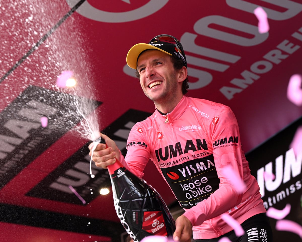 Colle de Lys in Italy - a man in a pink shirt is spraying champagne into the air.