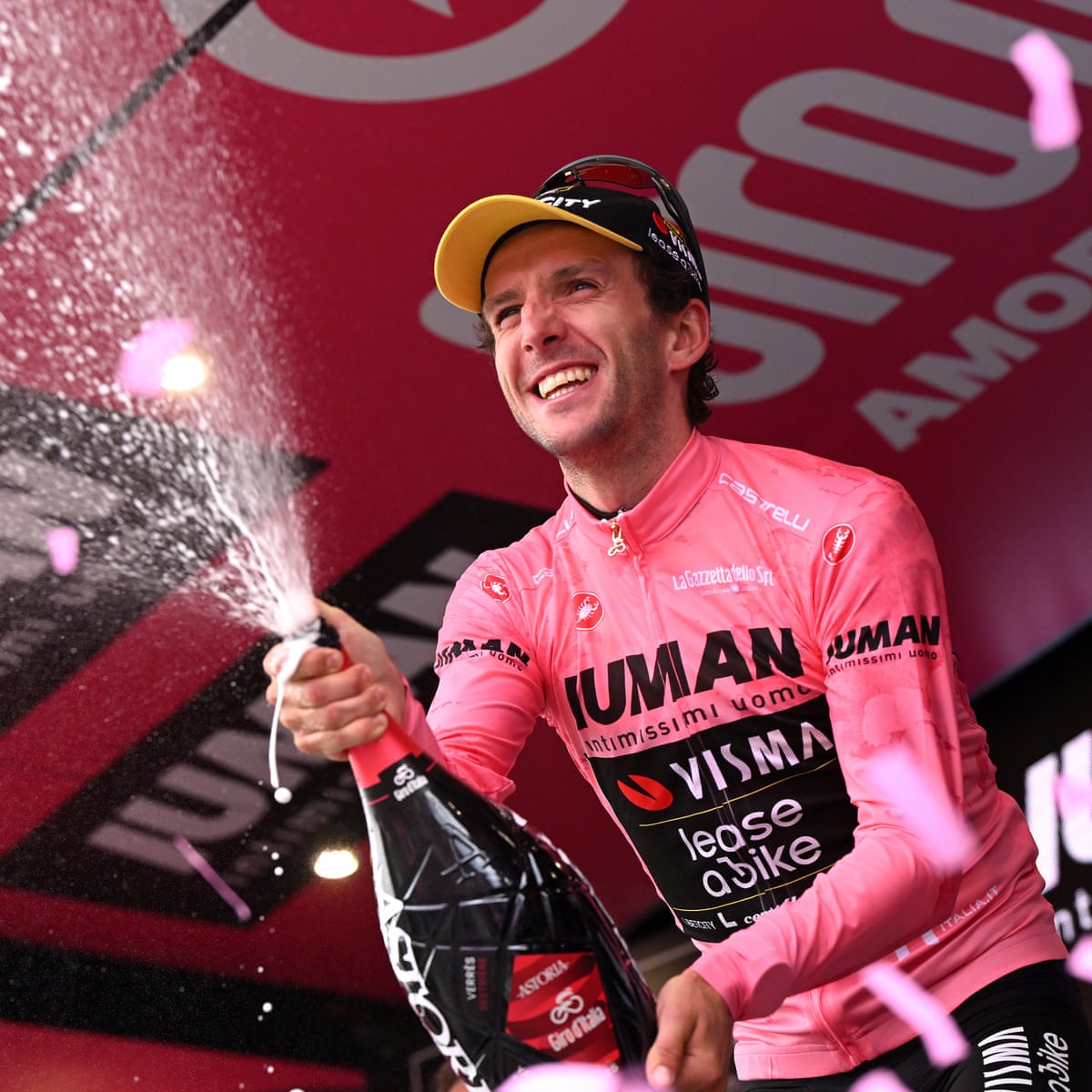 Colle de Lys in Italy - a man in a pink shirt is spraying champagne into the air.