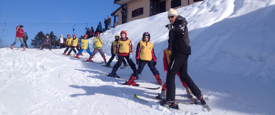 Passo Penice in Italy - a group of people skiing down a snowy hill.
