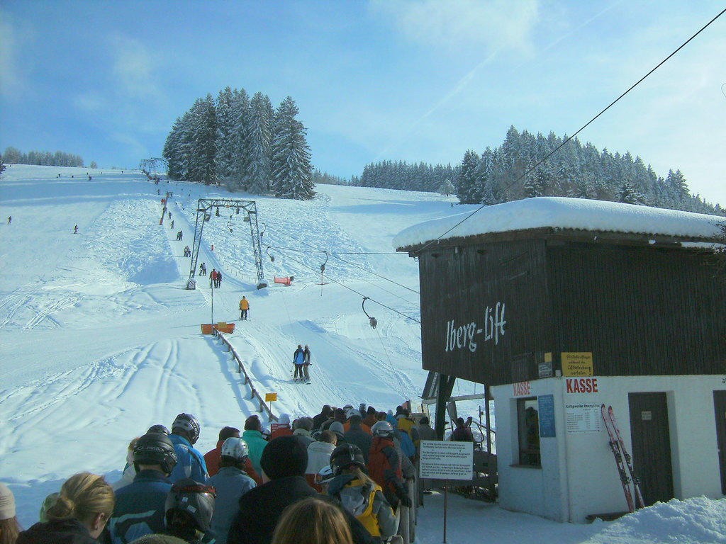 Oberberg – Weiler-Simmerberg in Germany - a group of people riding down a snow covered slope.