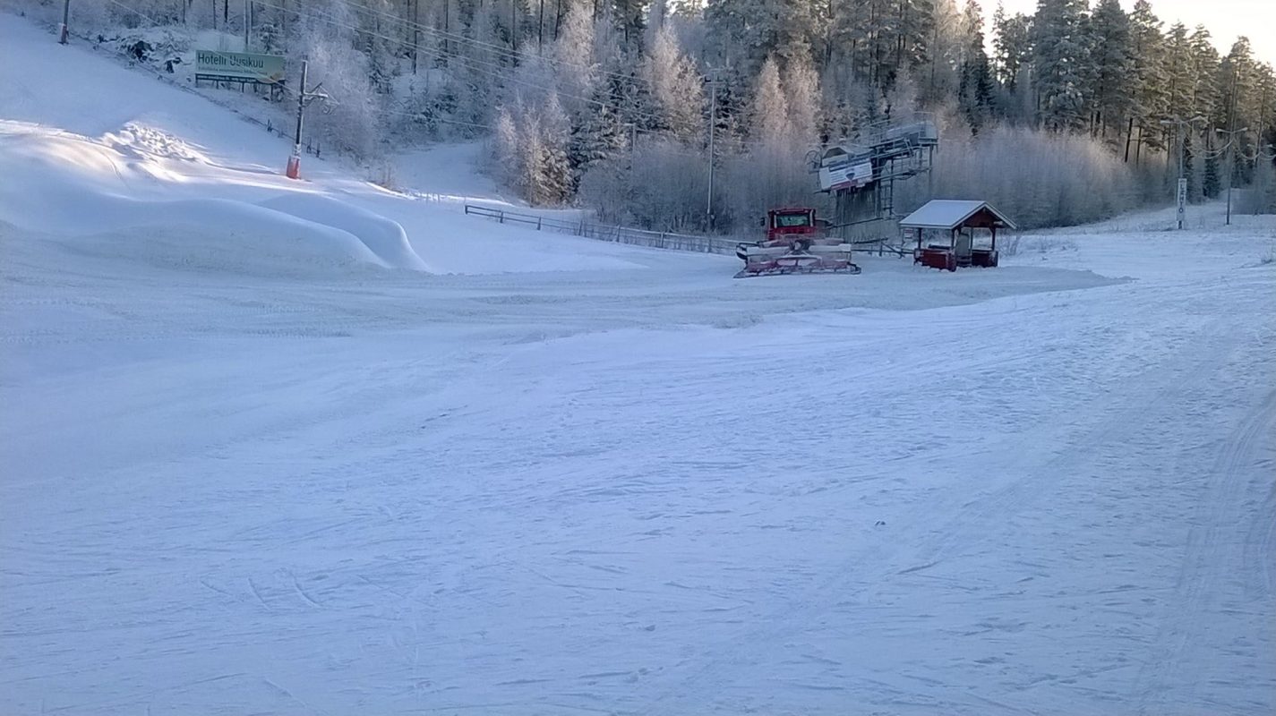 Tornimäki – Mikkeli in Finland - a snow covered ski slope with trees in the background.