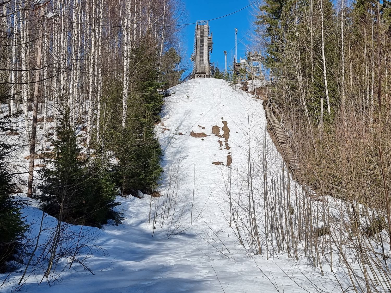 Tornimäki – Mikkeli in Finland - a ski slope with trees and snow on it.