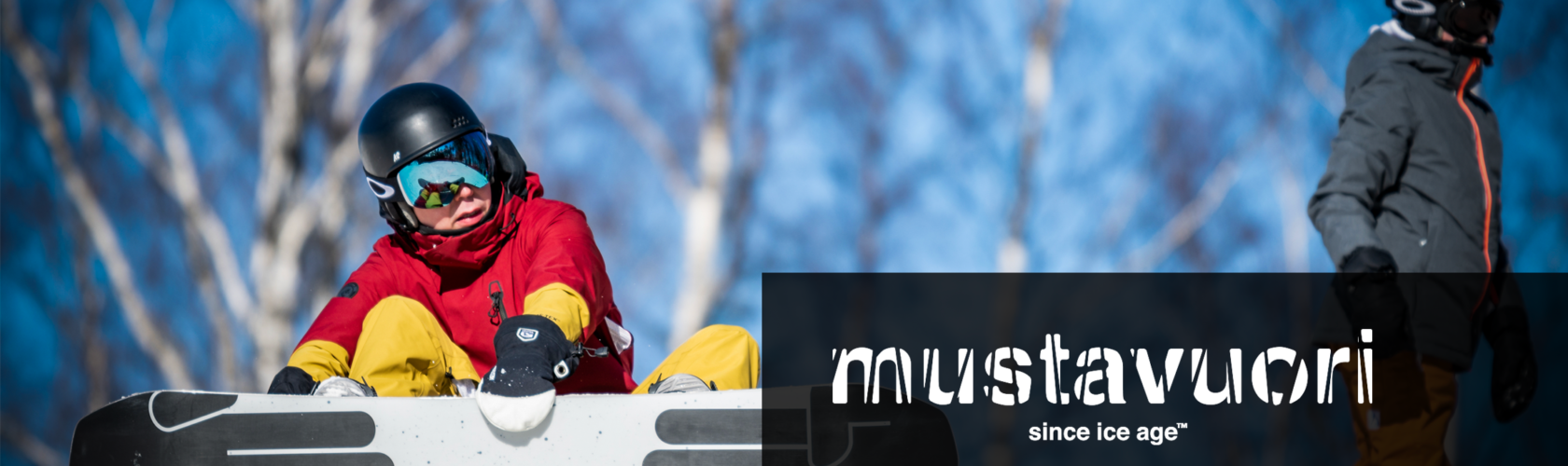 Mustavuori – Tampere in Finland - a man riding a snowboard down a hill.