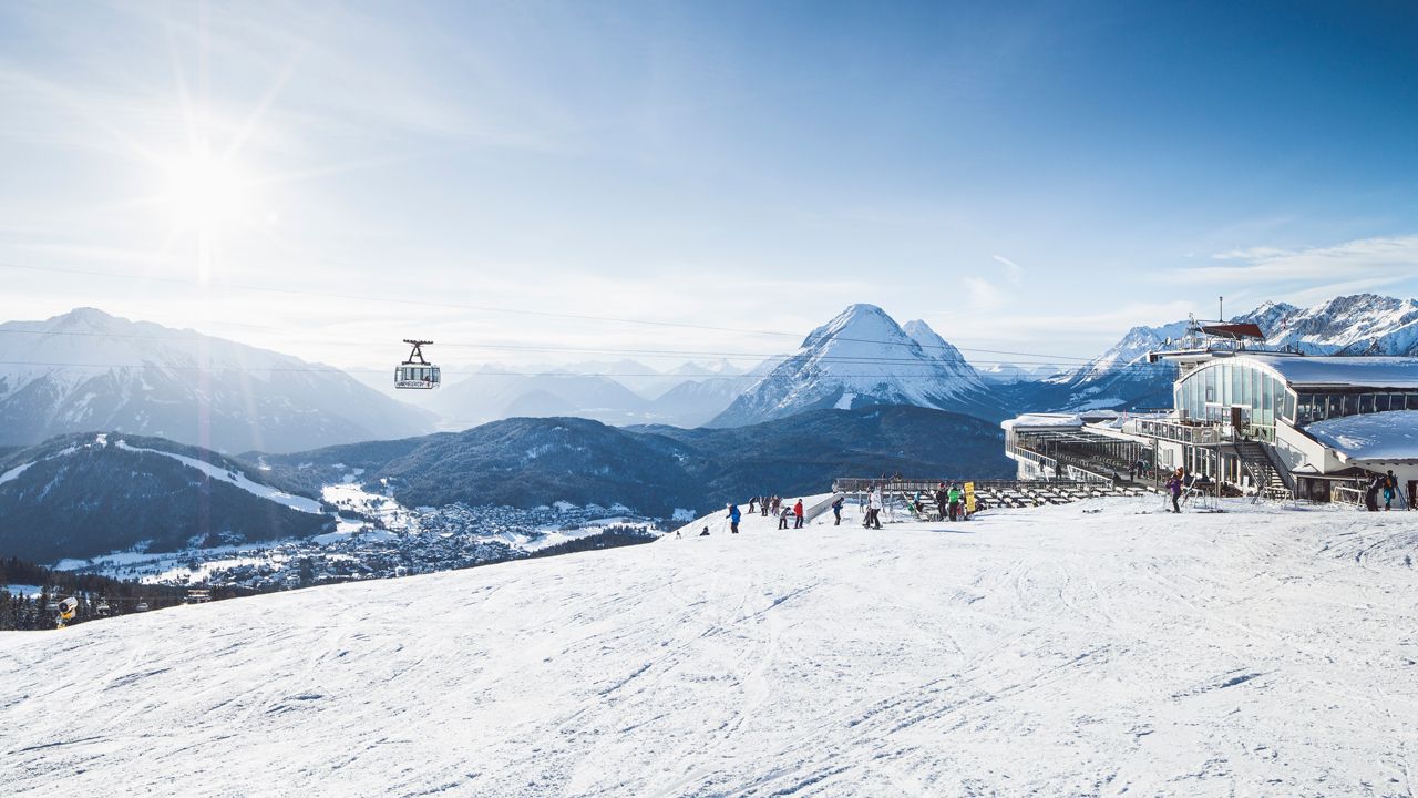Rosshütte – Seefeld in Austria - a ski slope with people skiing down it.