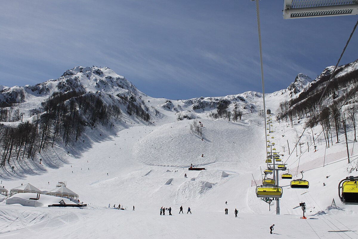 Rosa Khutor in Russia - a ski lift going up a snowy mountain.