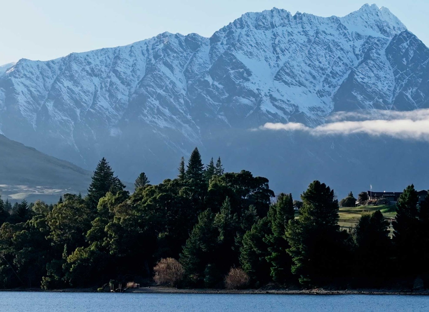 The Remarkables in New Zealand - a view of a lake with mountains in the background.