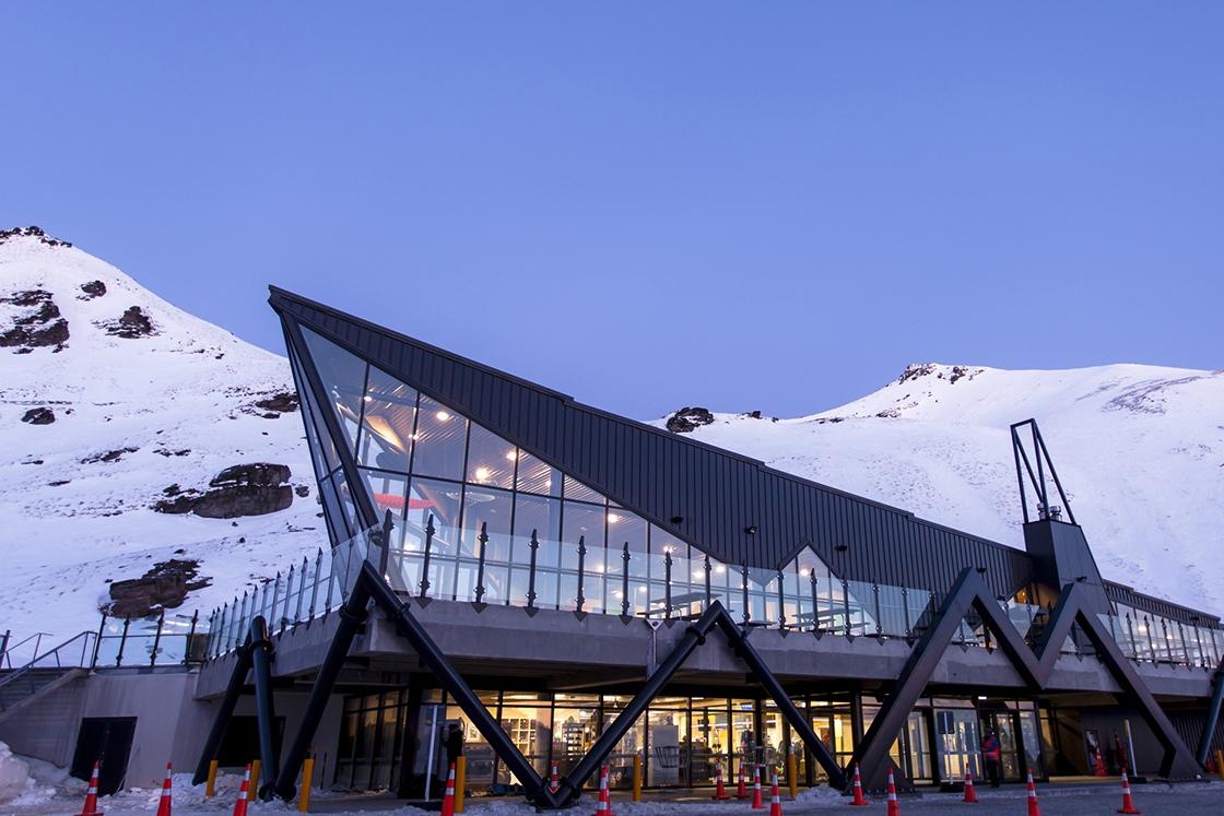 The Remarkables in New Zealand: a building in the middle of a snowy mountain.