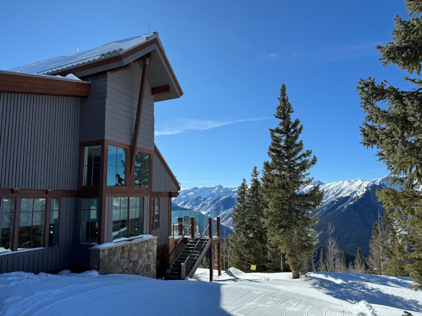 Aspen Mountain in USA - a house in the snow with mountains in the background.