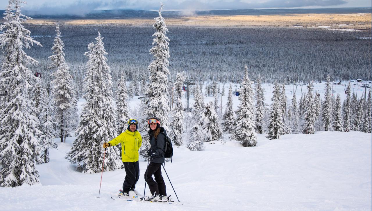 Kaustinen in Finland - a man in a yellow jacket is skiing down a snowy slope.