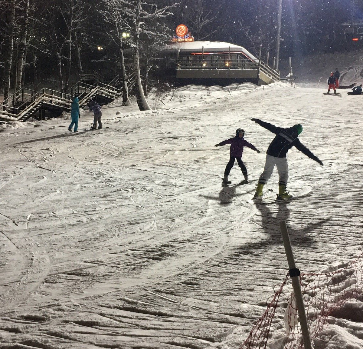 Yakhroma Park in Russia - a group of people riding down a snow covered slope.