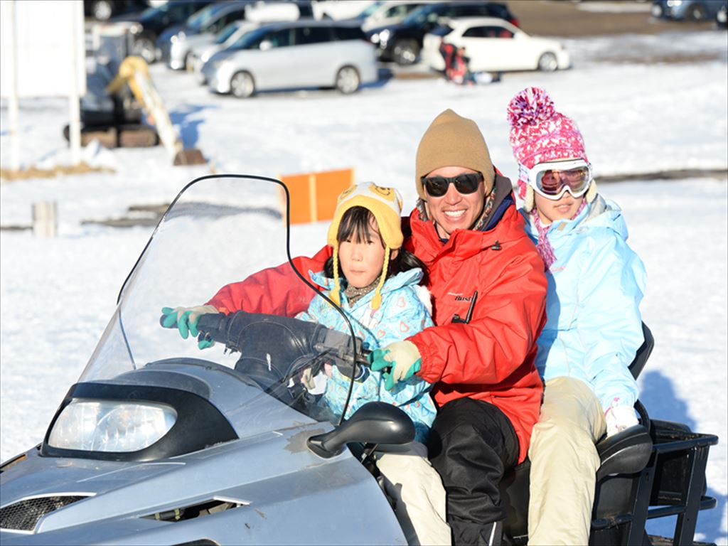 Blanche Takayama in Japan - a man and two children on a snowmobile.
