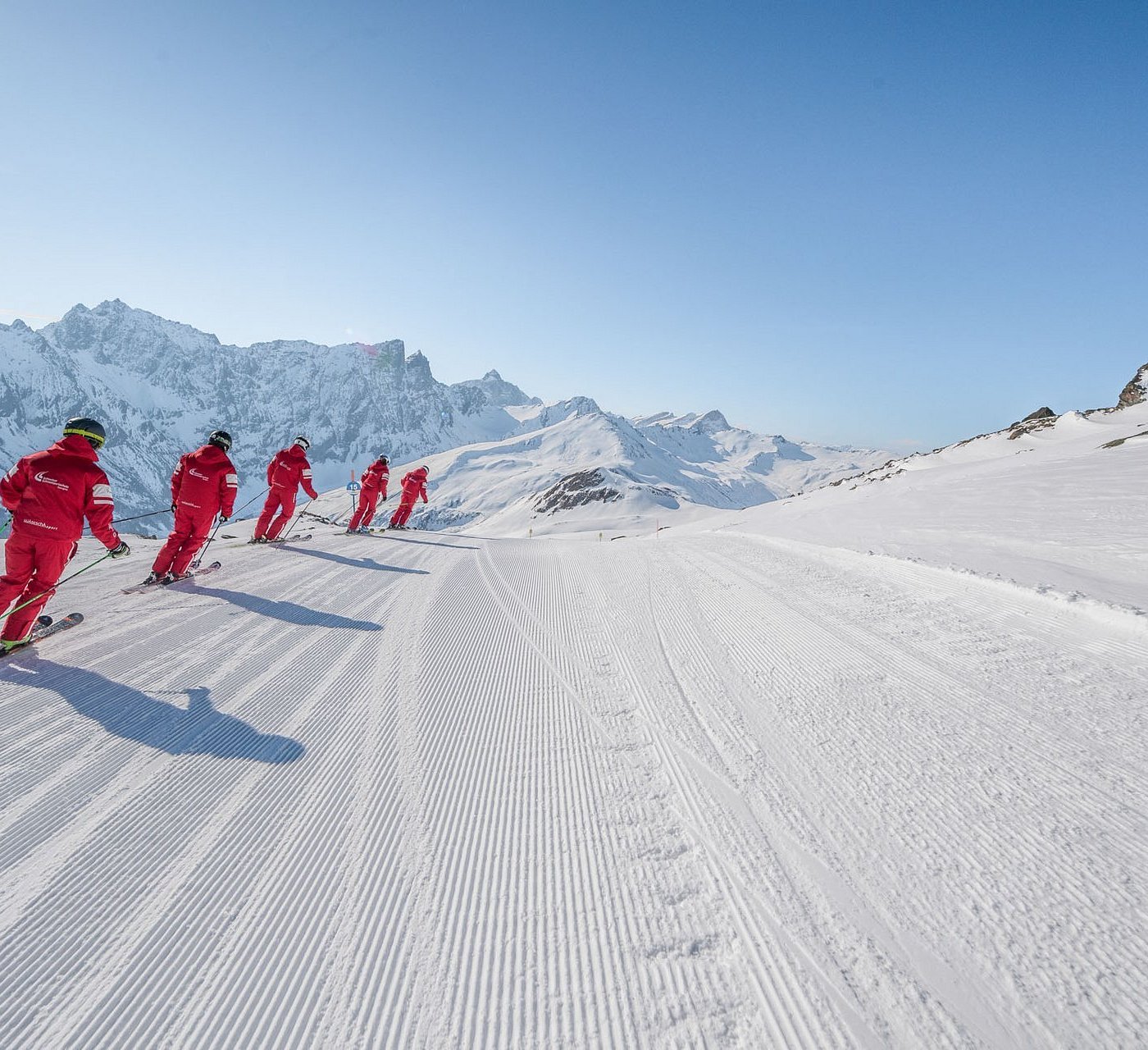 Savognin in Switzerland - a group of people skiing down a snow covered mountain.