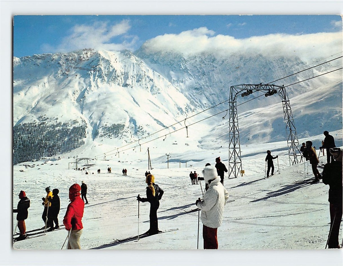 Savognin in Switzerland - a group of people standing on top of a ski slope.